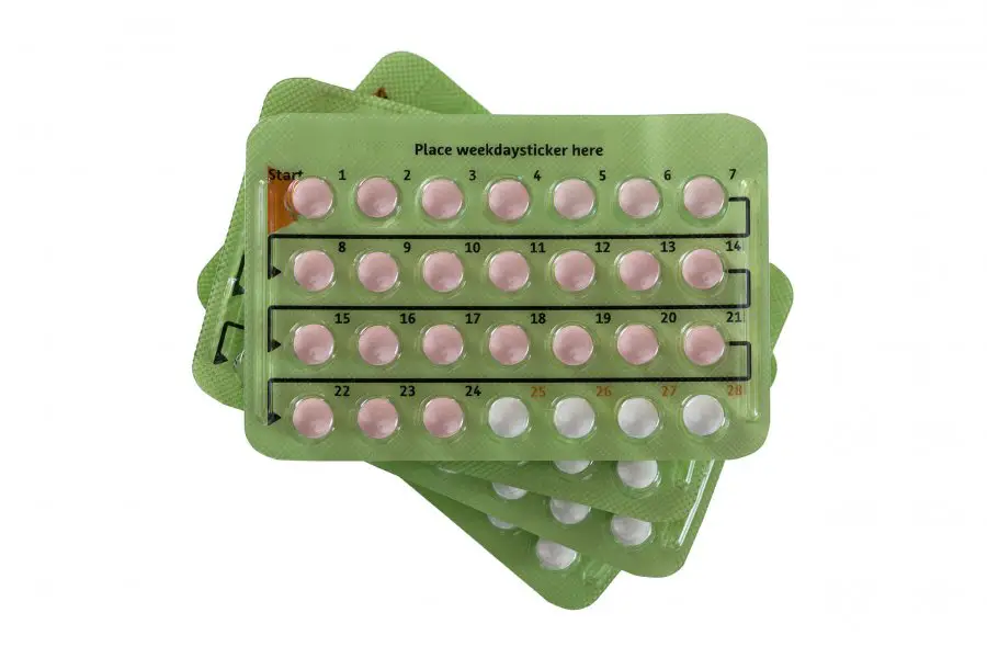 Stack of Birth control pill in 28 pill packages. There are 24 hormone