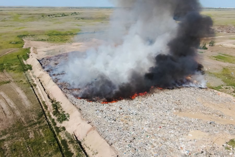 Burning trash. fire at the landfill. Burning garbage. Garbage dump, top view of the trash. Landfill.