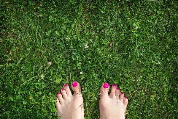 bare feet on the green grass 2021 08 29 01 01 09 utc